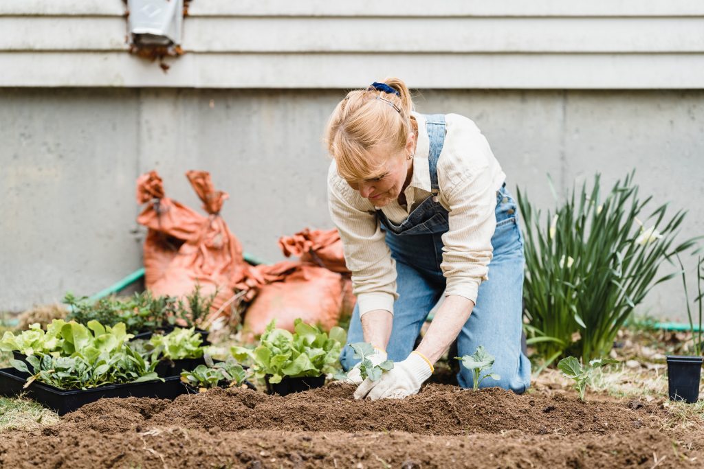 older woman tending a garden