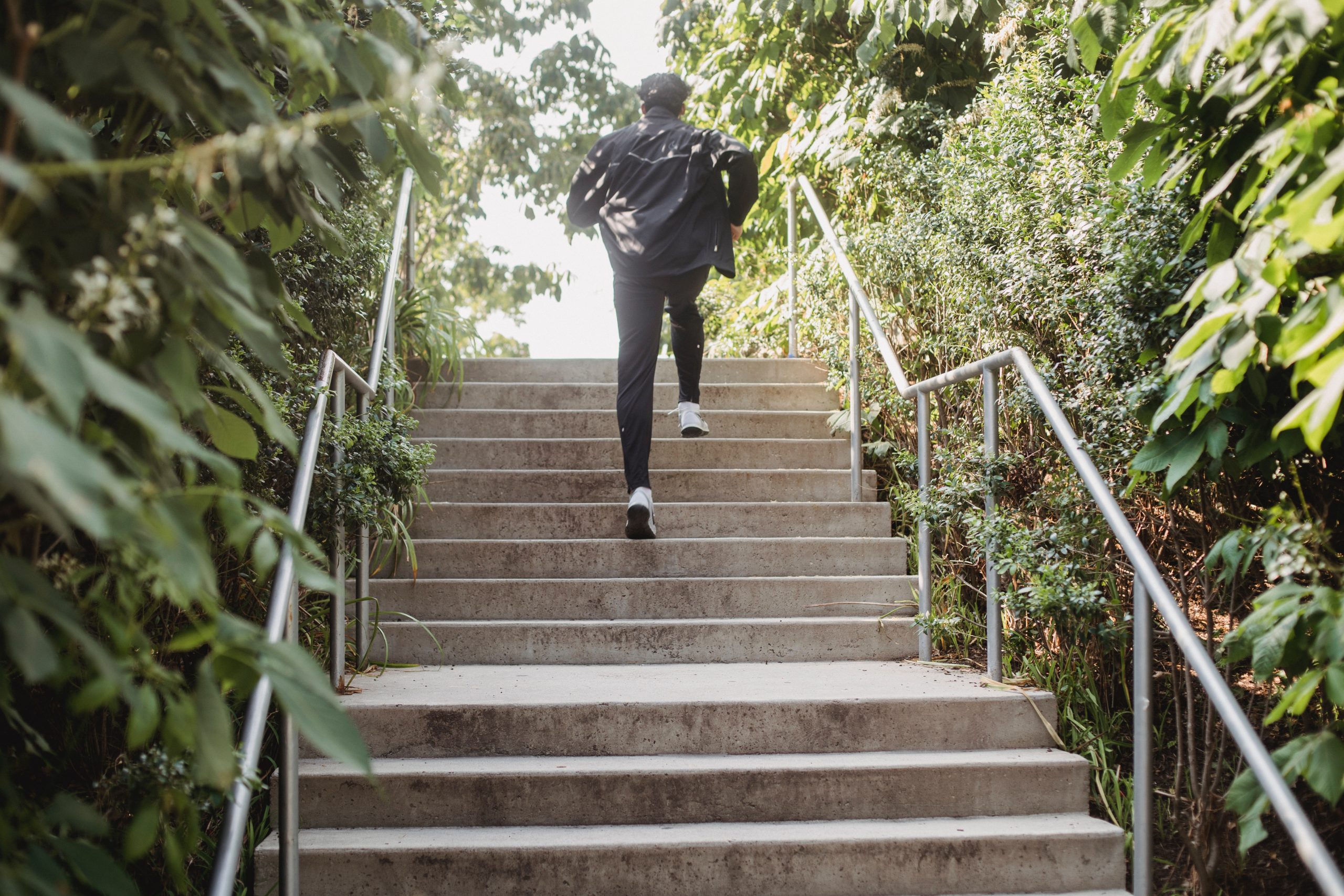 man running up an outdoor flight of stairs