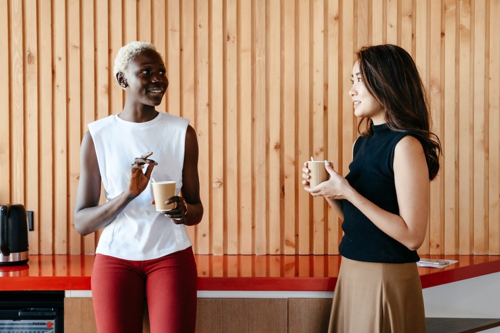 coworkers talking over coffee at daytime meeting