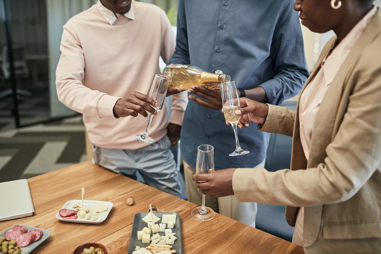 coworkers pouring champagne at a work event