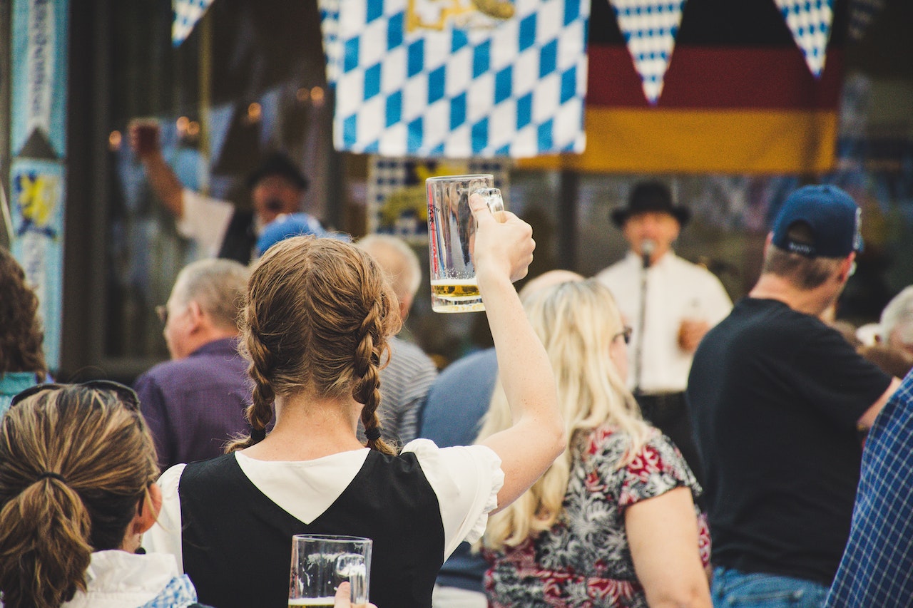 woman raising nearly empty beer glass at oktoberfest