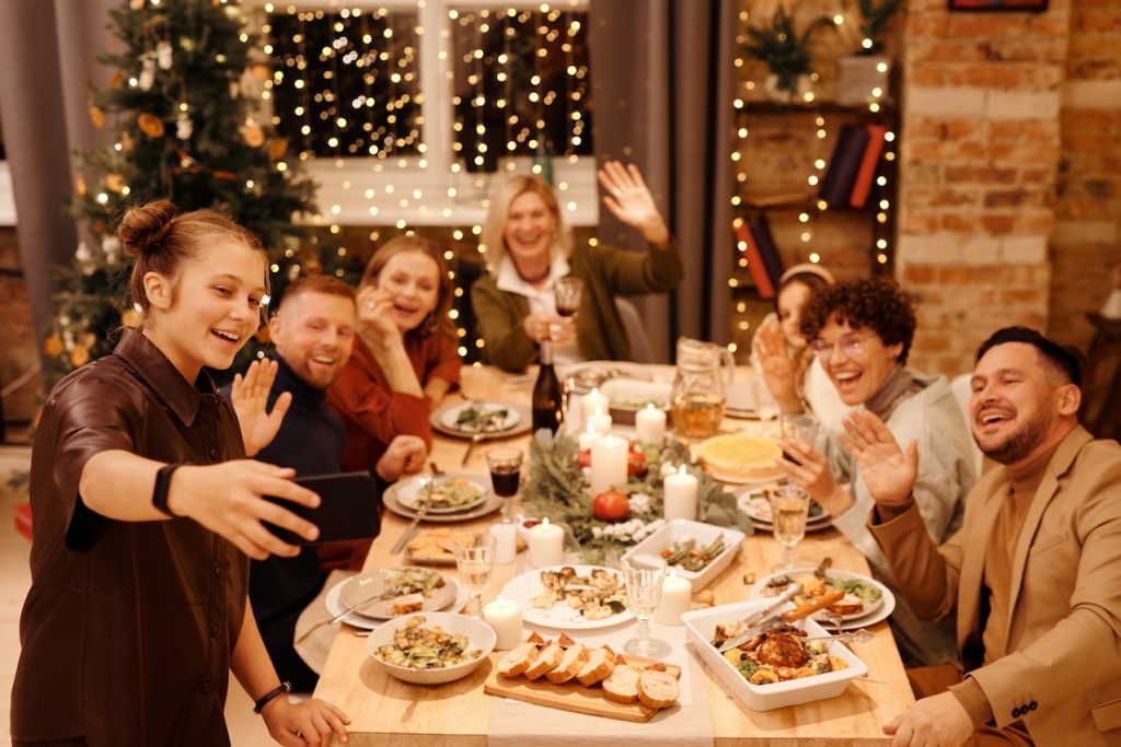 happy holiday family gathering around dinner table