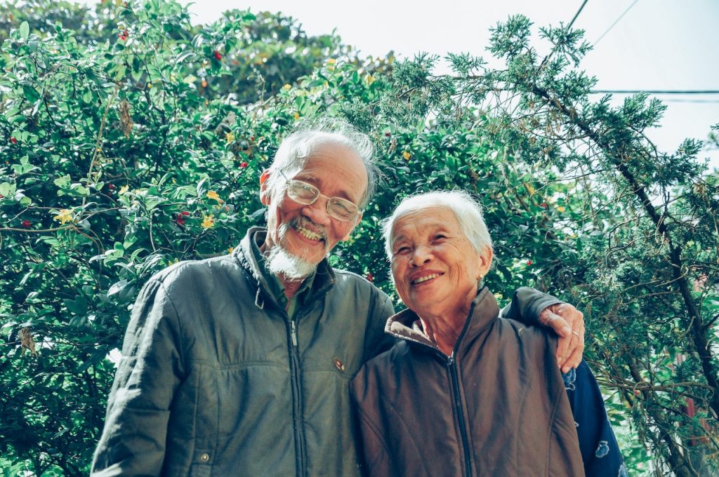 elderly couple in an orchard