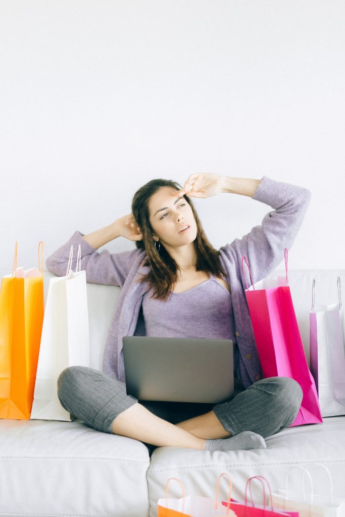 woman with shopping bags taking a break on couch