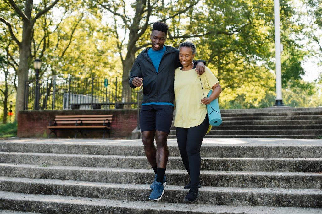 man and woman descending staircase in public park