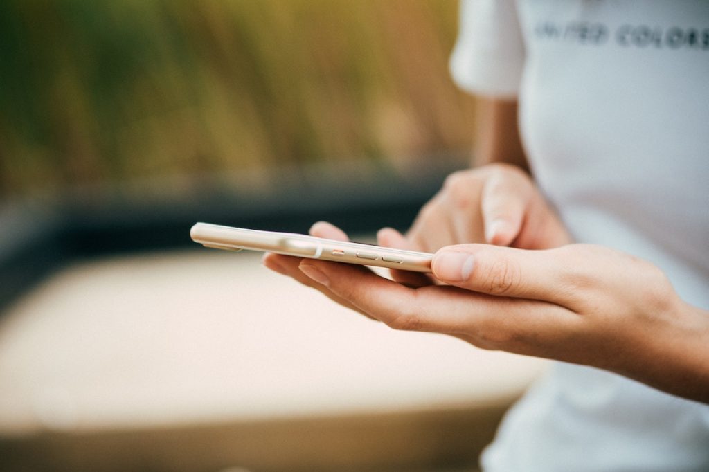 hands using smartphone on blurry background