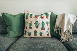 white and green throw pillow on couch