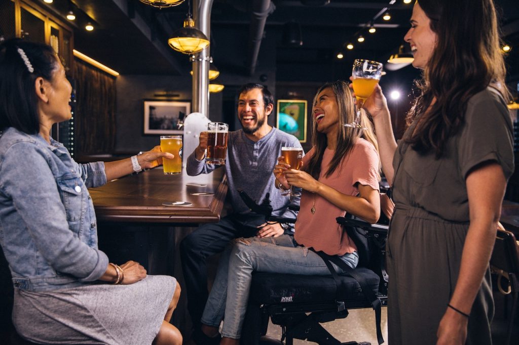 Friends drinking beer together at bar