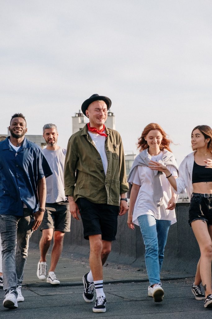 friends walking in a group outdoors on a clear day