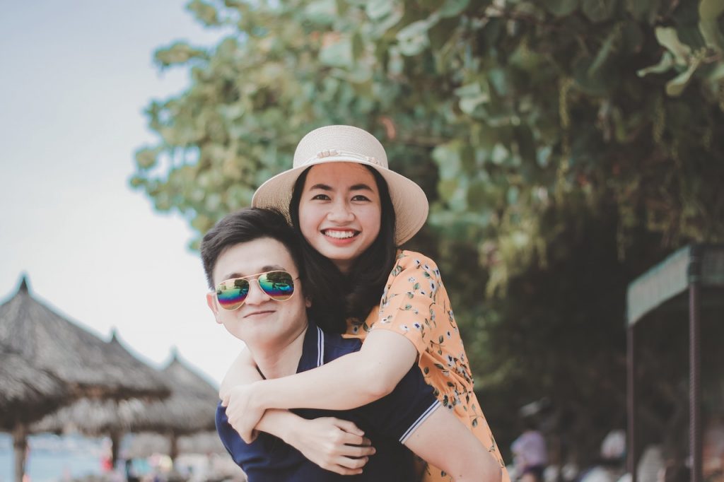 man carrying woman on his back